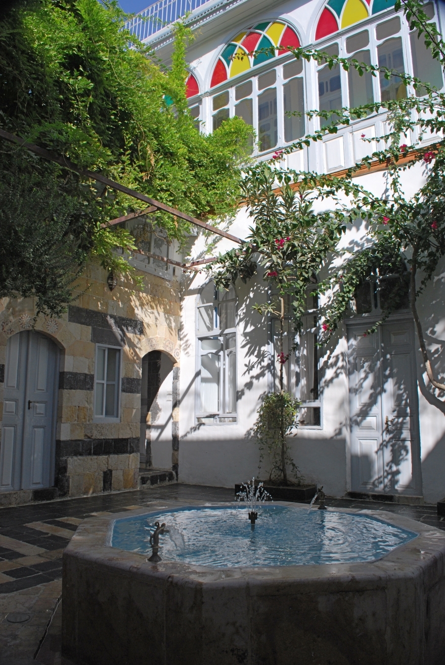 Bait Baroudi courtyard with fountain working, view towards the northern 19th century facade. Bait Baroudi courtyard with fountain working, view towards the northern 19th century facade.